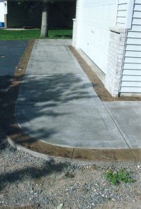 Replaced sidewalk and apron added a stained  border.